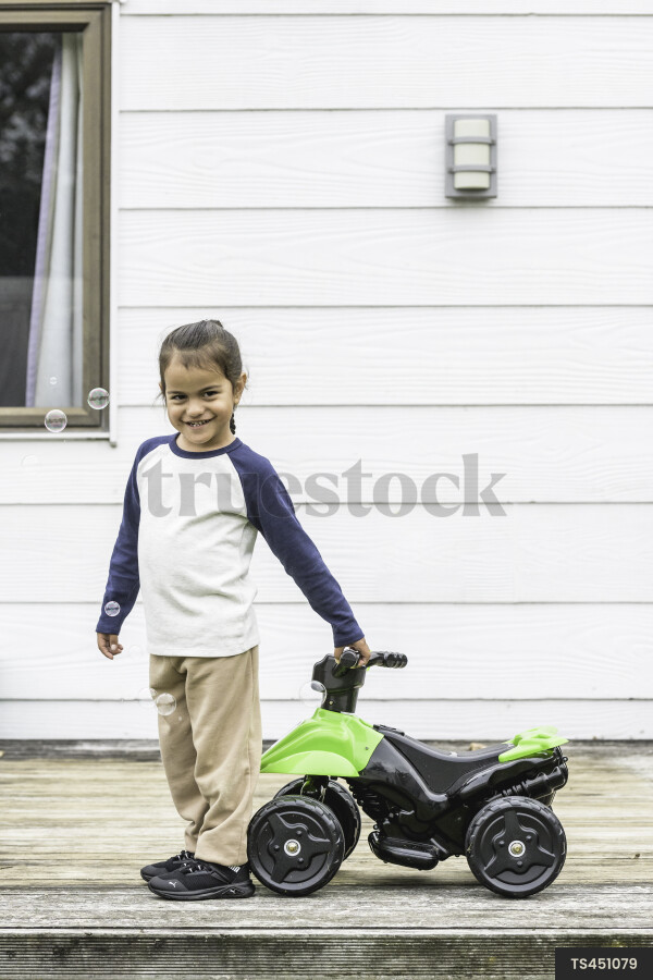 Girl with toy quad bike