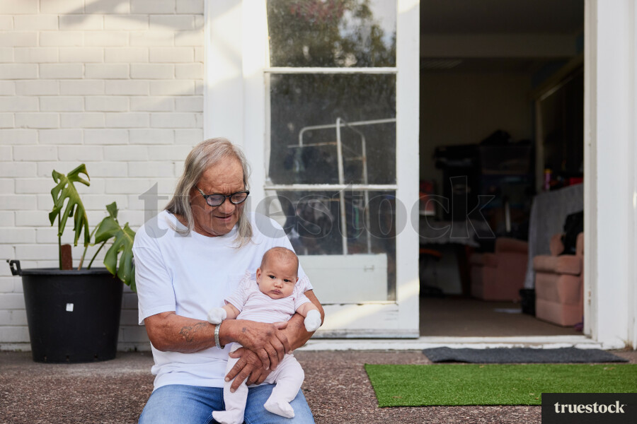Grandfather Holding Granddaughter on Back Porch