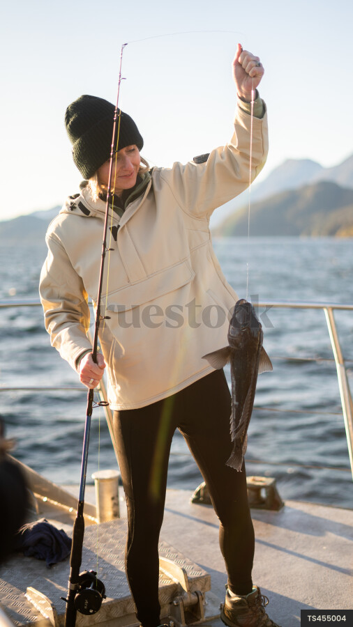 Woman fishing on boat