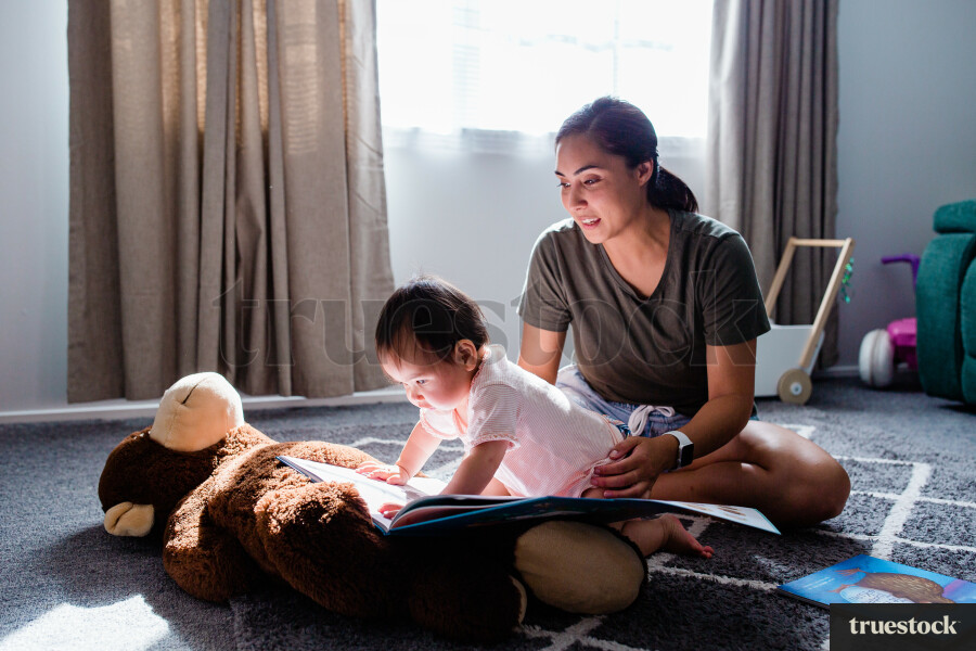Maori mother reading with child