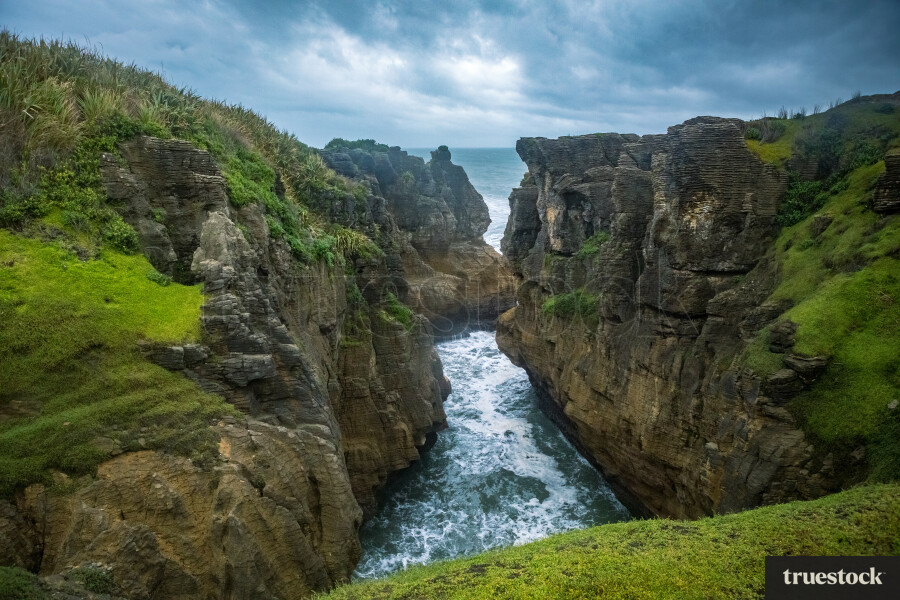 Landscape of rocky coast and ocean waves on an overcast day
