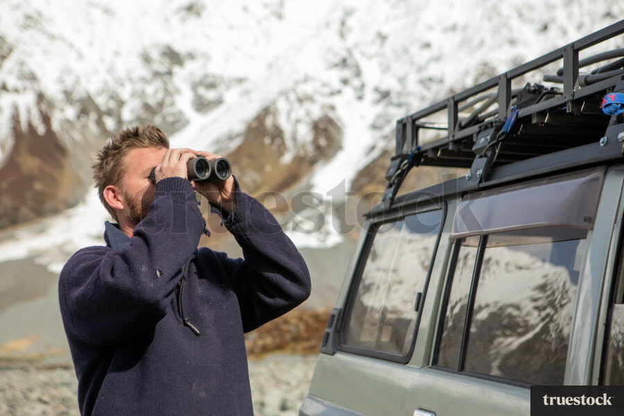 Man looking through binoculars