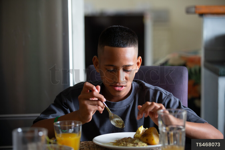 Tongan boy eating traditional food for lunch