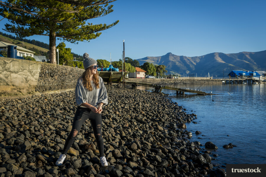 Teenagers Throwing Stones in Water