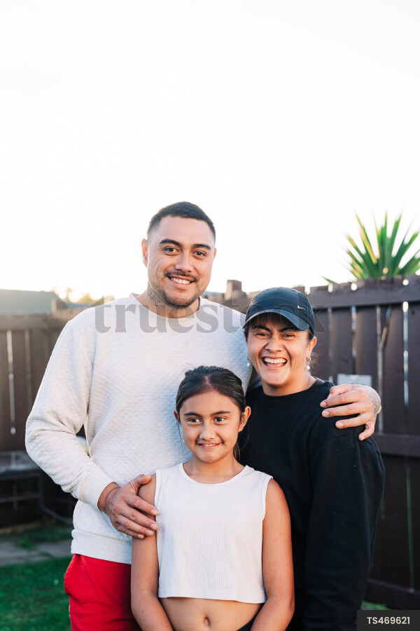 Portrait of happy Maori family in garden