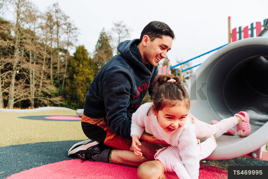 Young Girl on Slide at Park