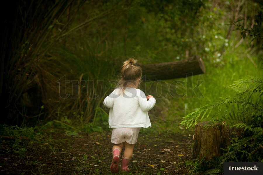 Toddler running through the forest