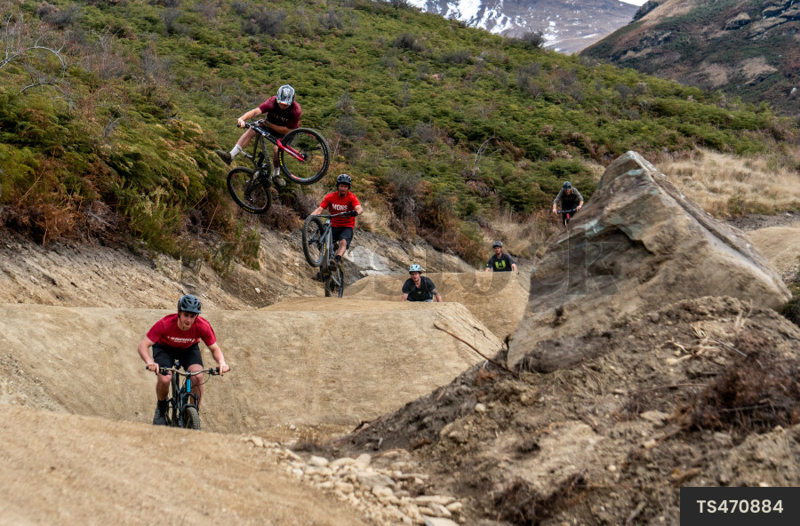 Men mountain biking on dirt trail