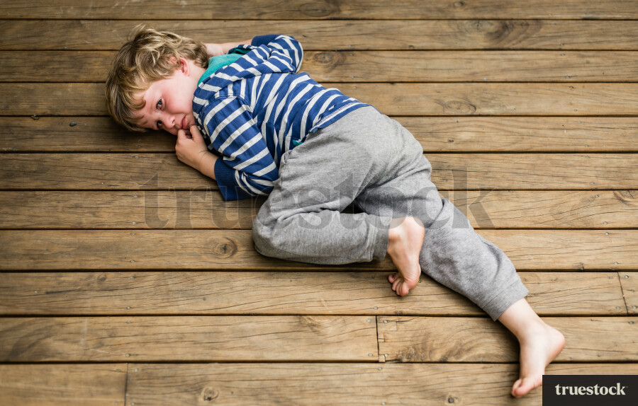 Upset child on wooden deck