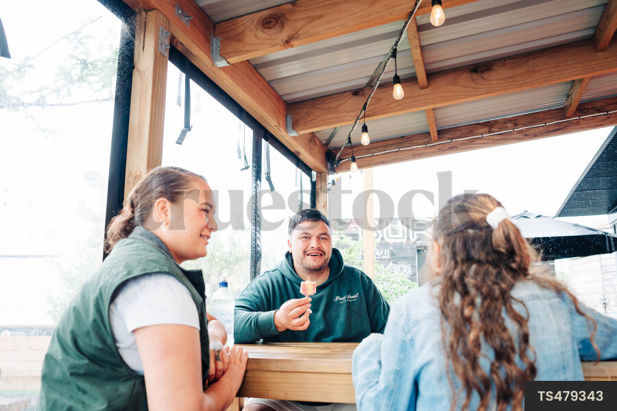Family sitting at table in restaurant