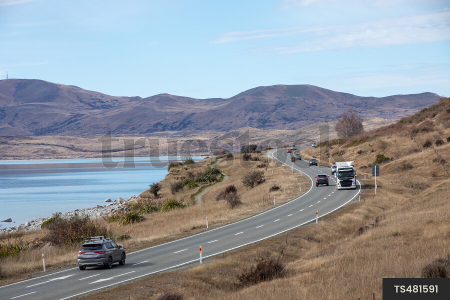 Vehicle Driving Next to Lake