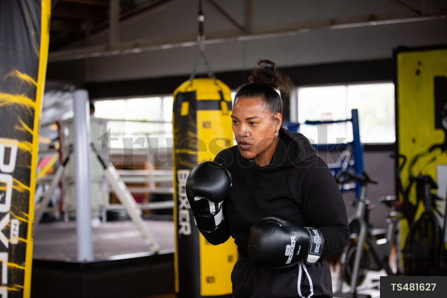 Boxer Practicing with Punching Bag