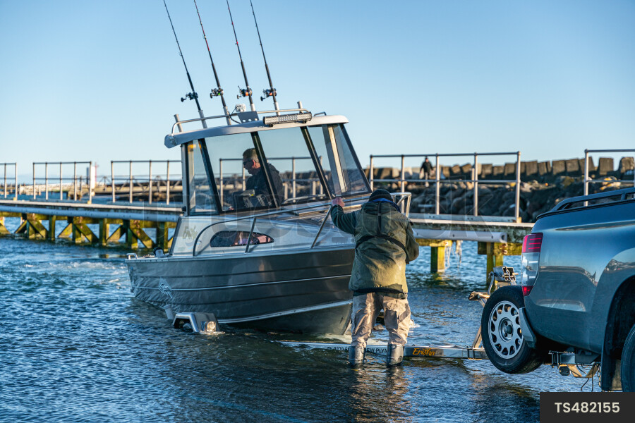 Men launching boat to sea