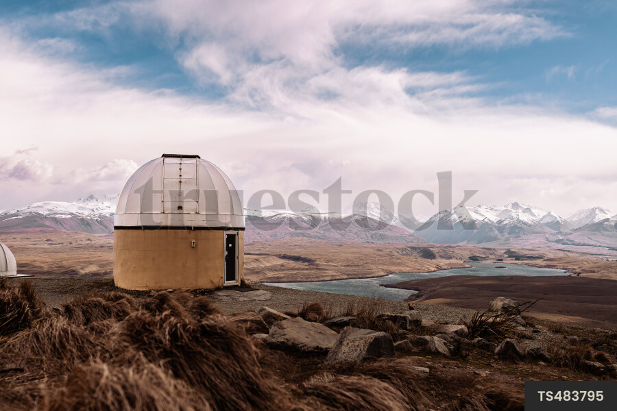 Landscape of building by lake and mountains