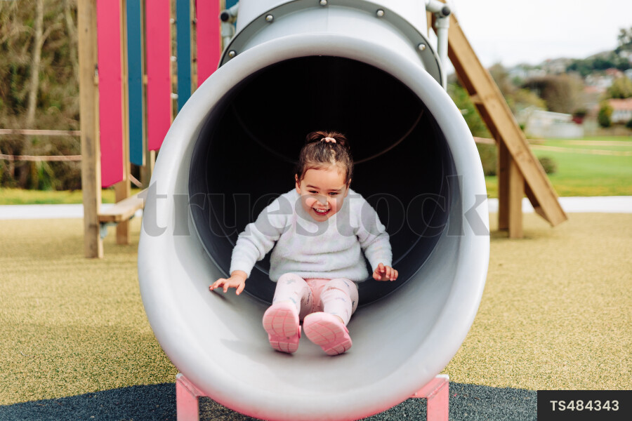 Young Girl on Slide at Park