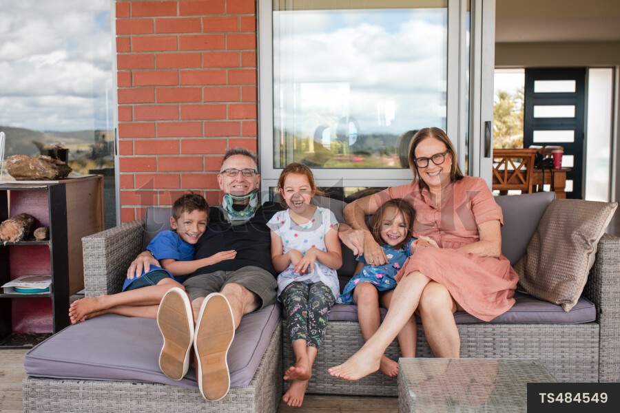 Man and woman sitting with their grandchildren