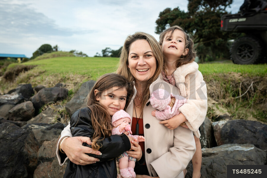 Woman with her daughters on beach
