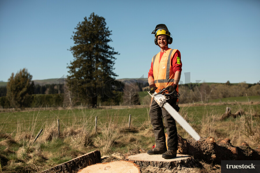 Worker Standing on Log