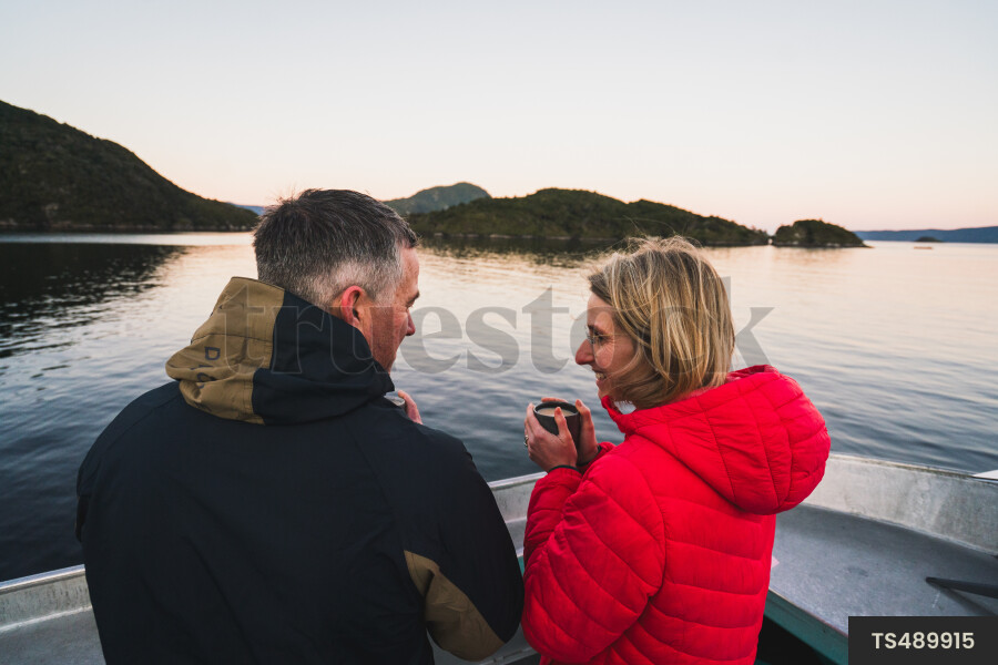 Couple on boat at sunset
