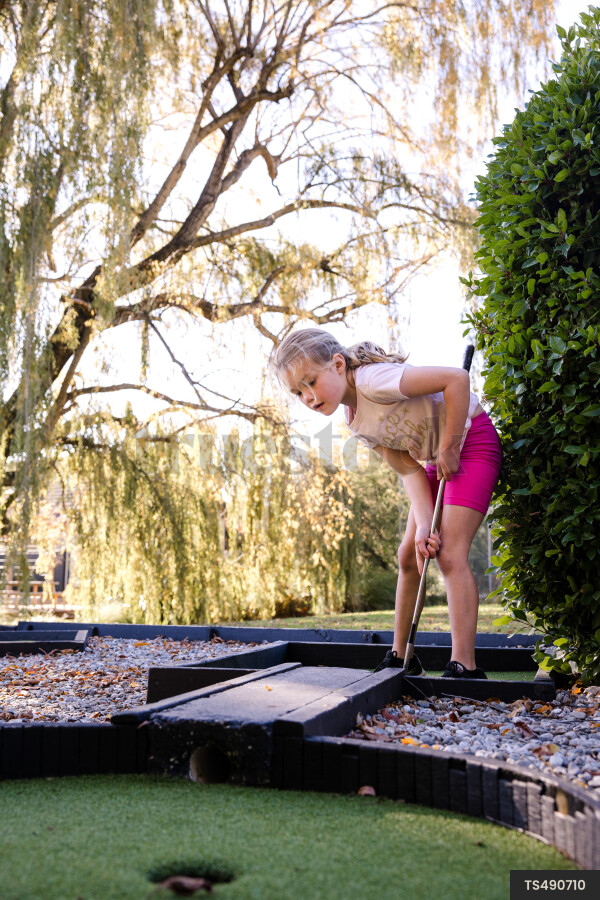 Girl playing miniature golf