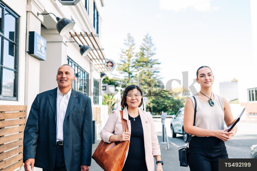 Businesspeople walking on city street