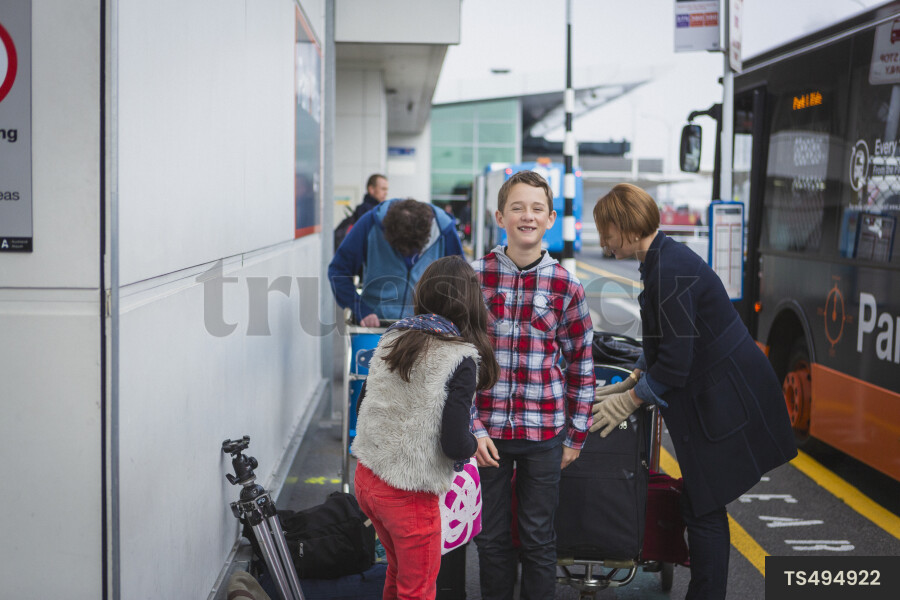 Family boarding bus at airport