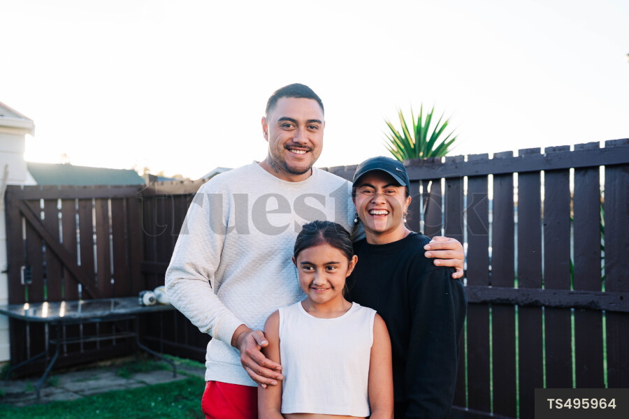 Portrait of happy Maori family in garden
