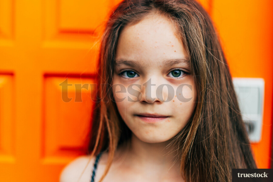 Portrait of Girl in front of Orange Door