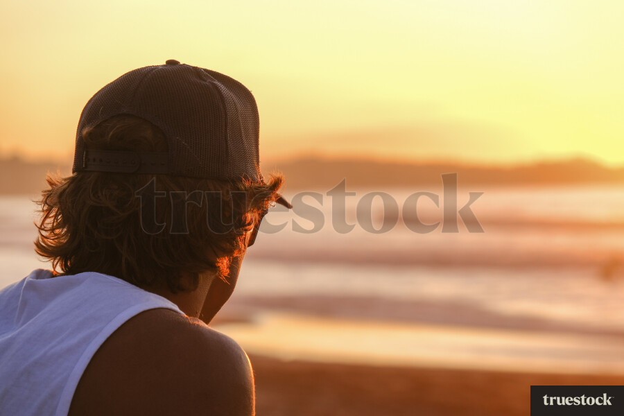 Adult watching the sunset at the beach