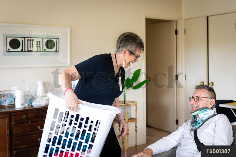 Health carer helping patient with laundry