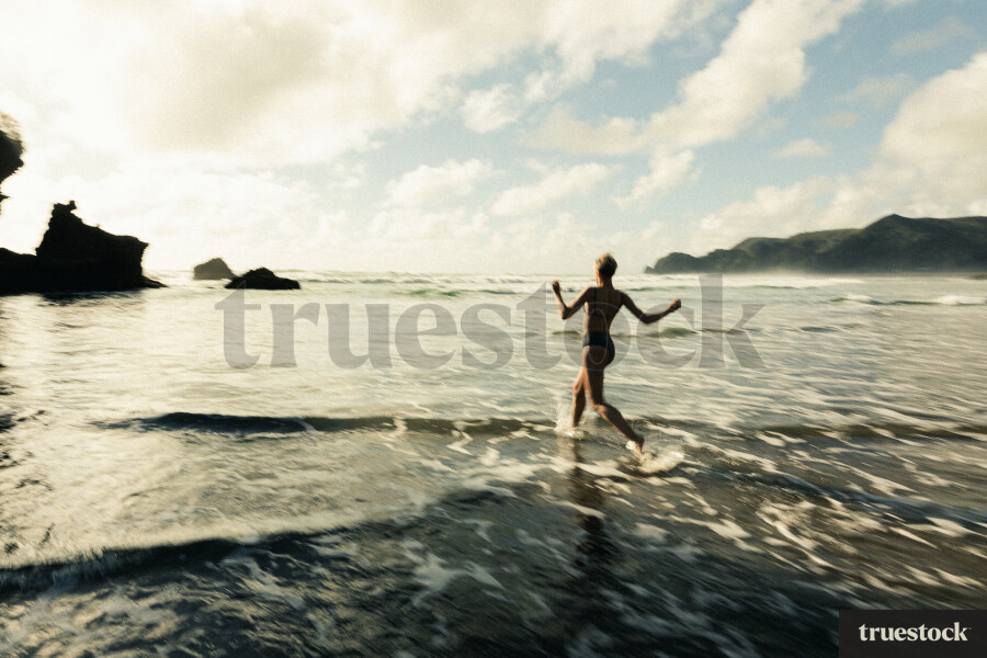 Woman Swimming at Piha Beach