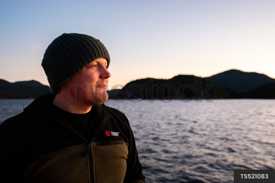 Man by sea at sunset