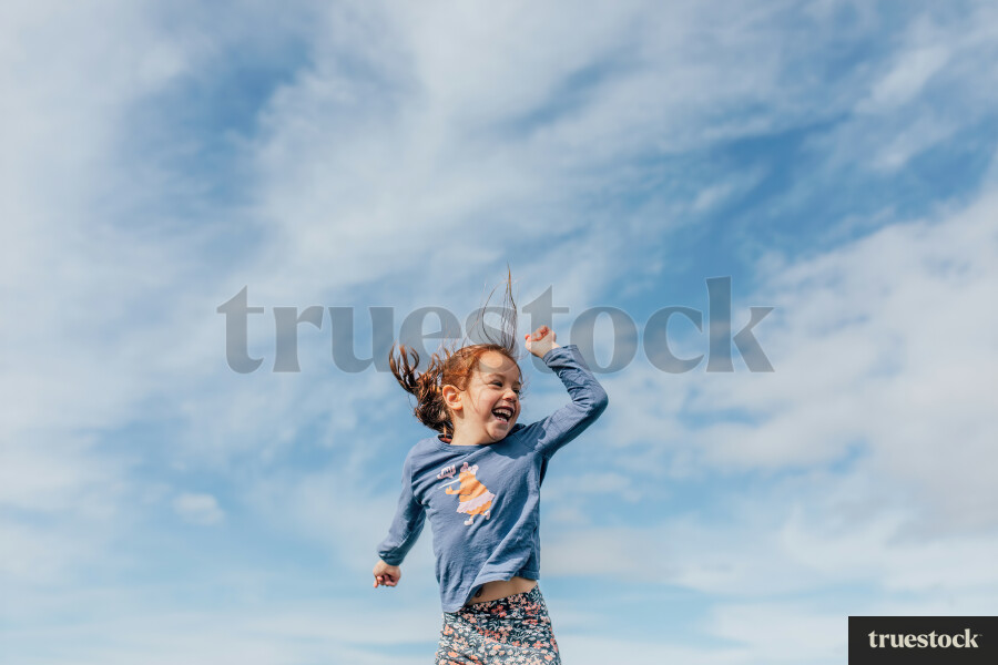 Young Girl Jumping on Trampoline