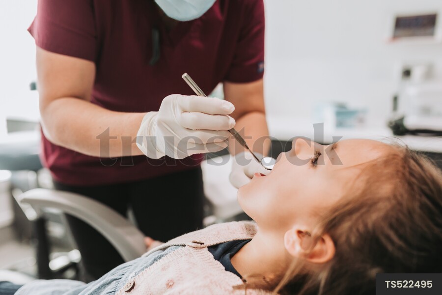 Patient and dentist with medical instrument in clinic