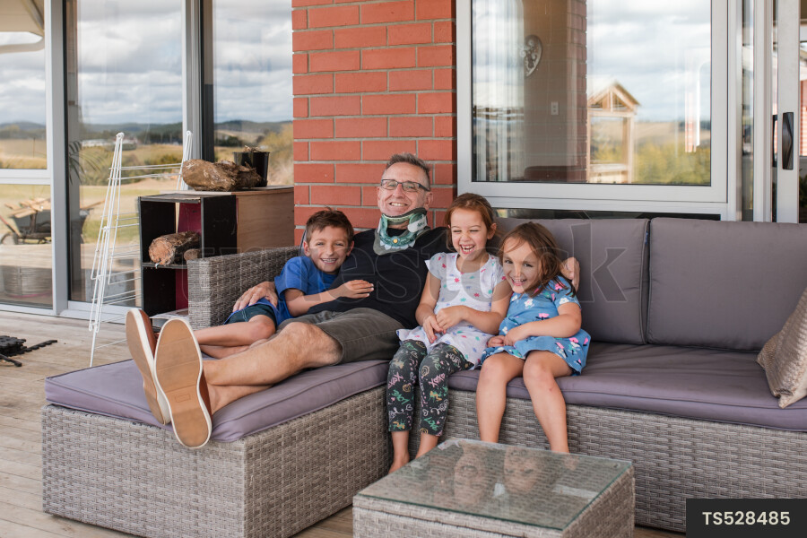 Man sitting with his grandchildren