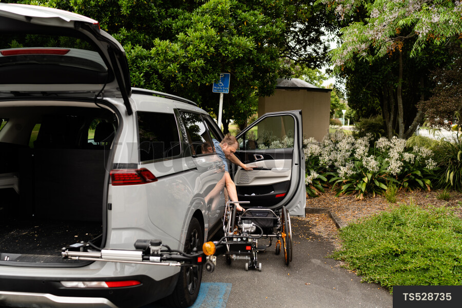 Man with wheelchair in car
