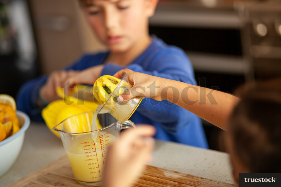 Young children making lemondade
