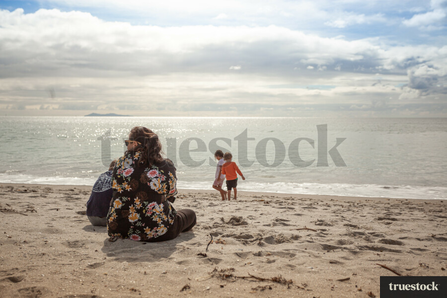 Mother and children on the sand at the beach