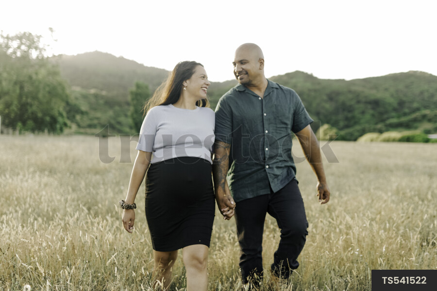 Husband and Pregnant Wife in Field