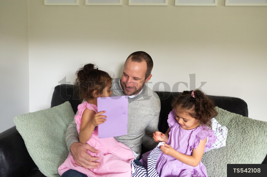 Man playing with his daughters