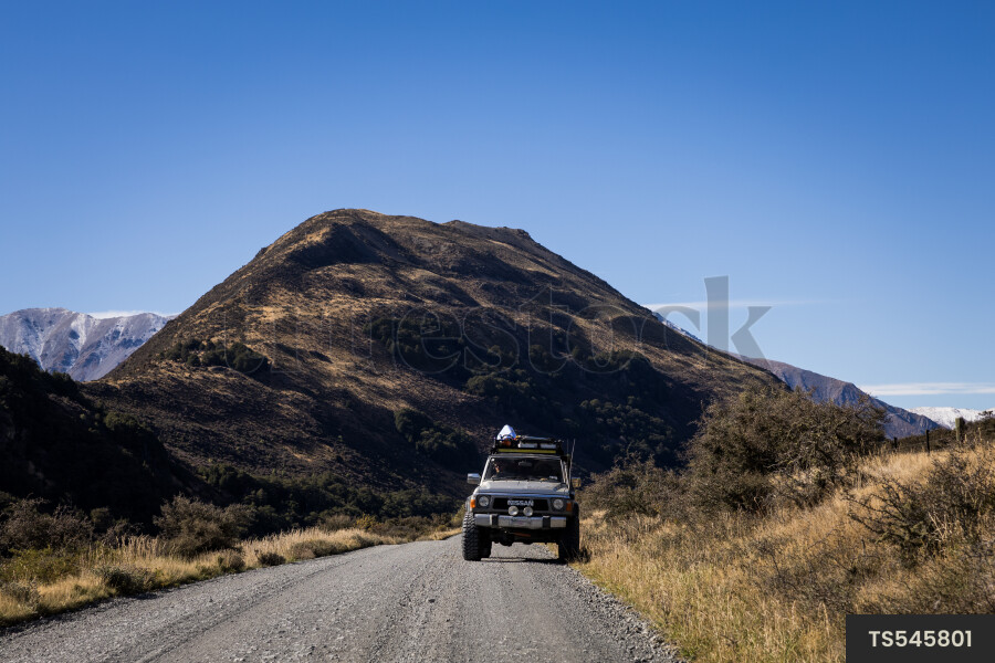 Four wheel drive on off-road vehicle on unpaved road in mountain