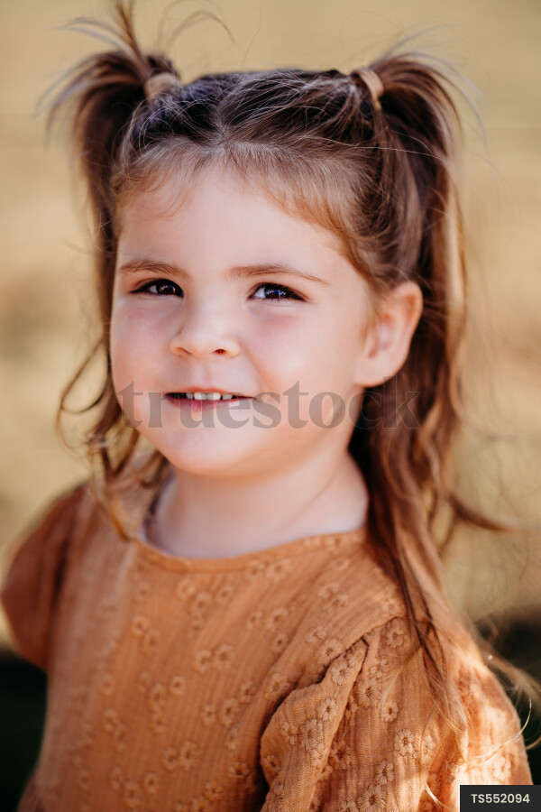 Portrait of cute brunette girl with pigtails