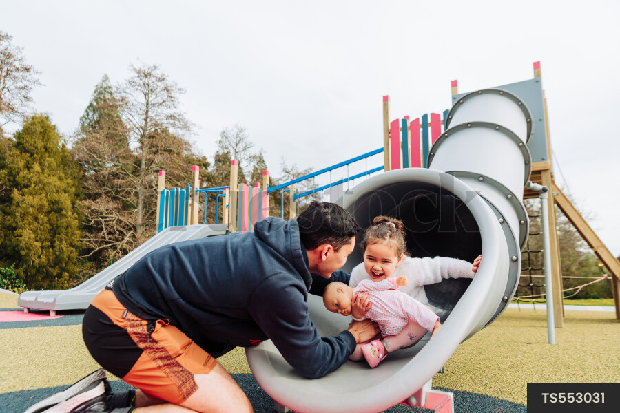 Young Girl on Slide at Park