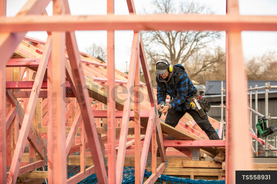 Tradie Working on Framing