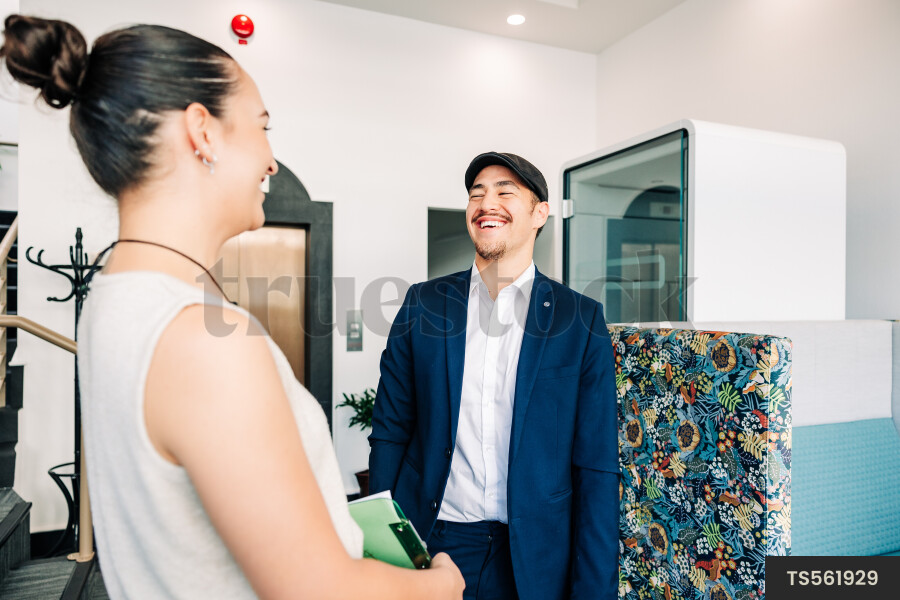 Young businesspeople smiling in office building