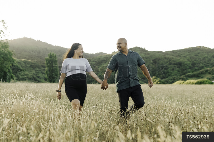 Husband and Pregnant Wife in Field