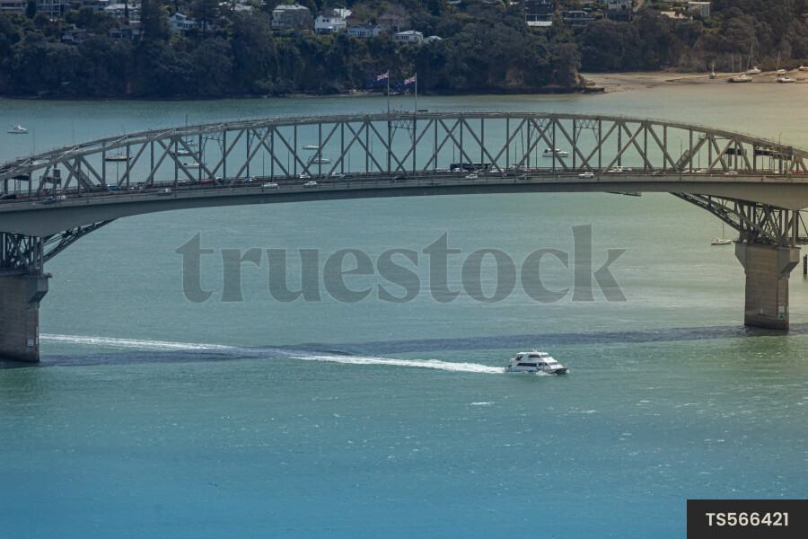 Boat under Harbour Bridge in Auckland