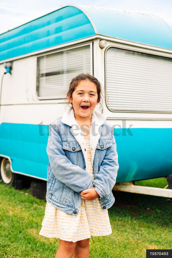 Smiling girl by trailer