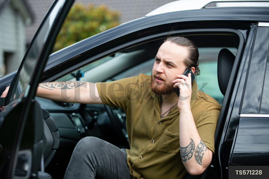 Man Using Phone in Car
