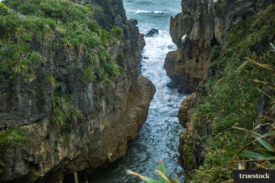 Landscape of rocky coast and ocean waves on an overcast day